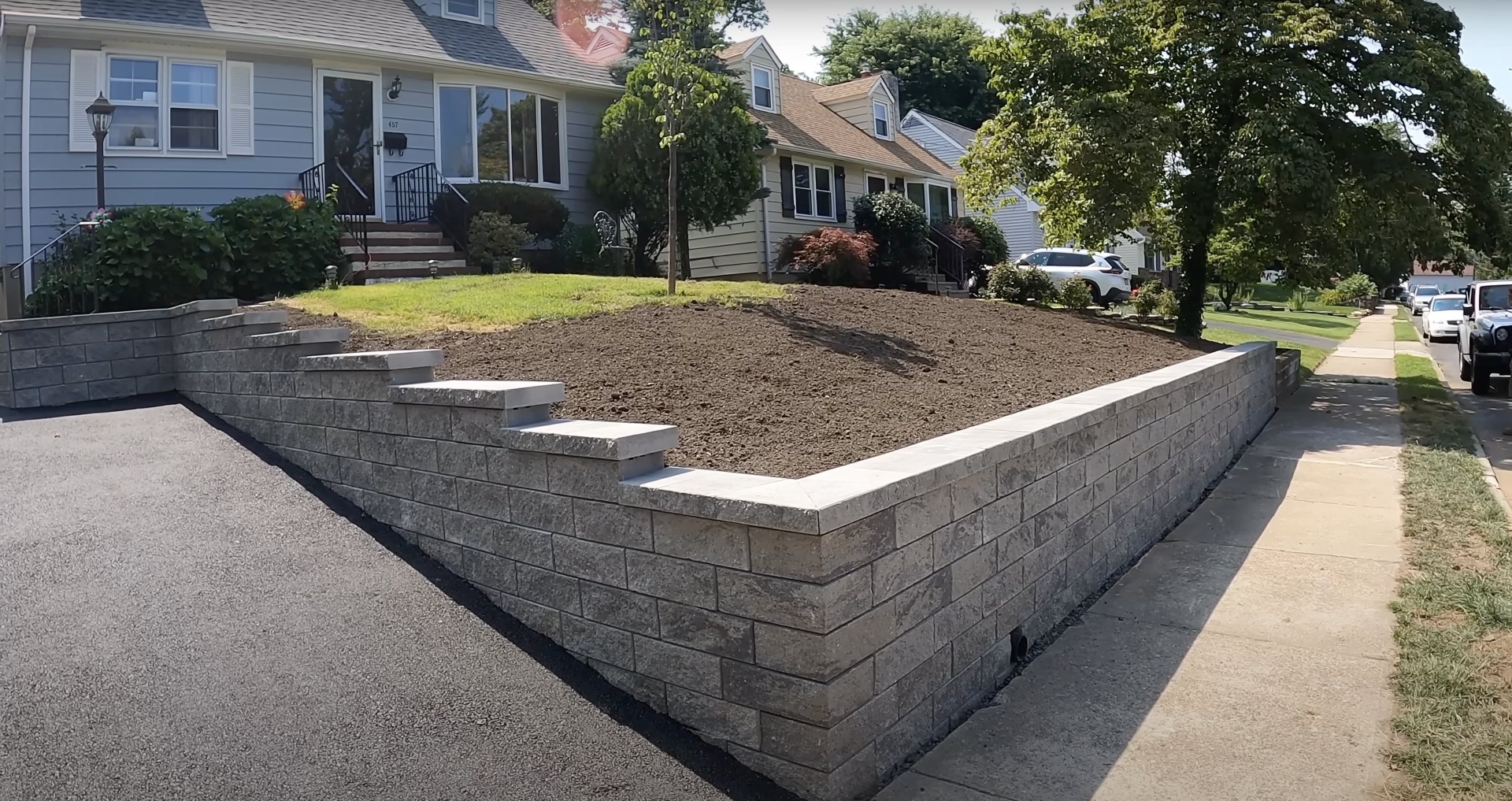 Residential concrete retaining wall construction with professional block installation