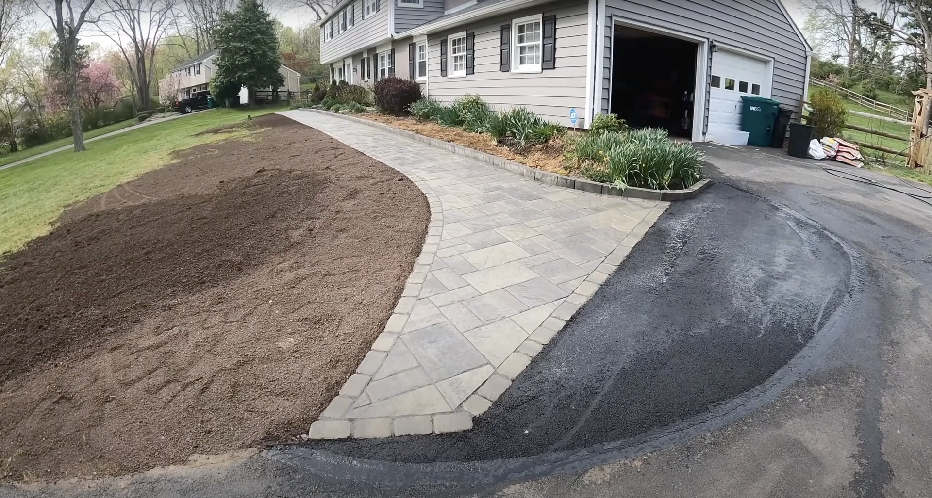 Curved stamped concrete driveway and walkway showing professional design and installation