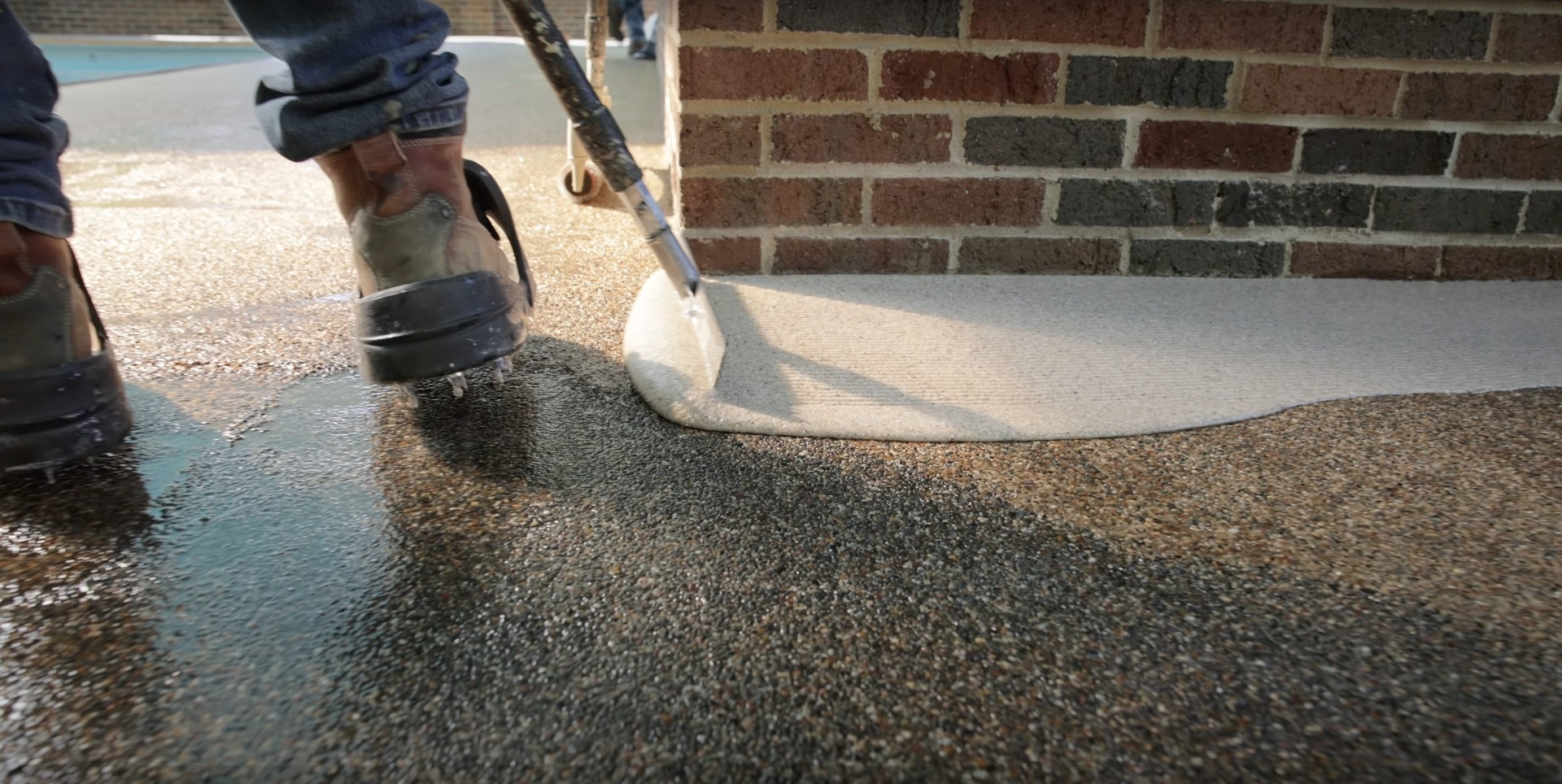 Professional concrete installation work showing smooth concrete pouring technique