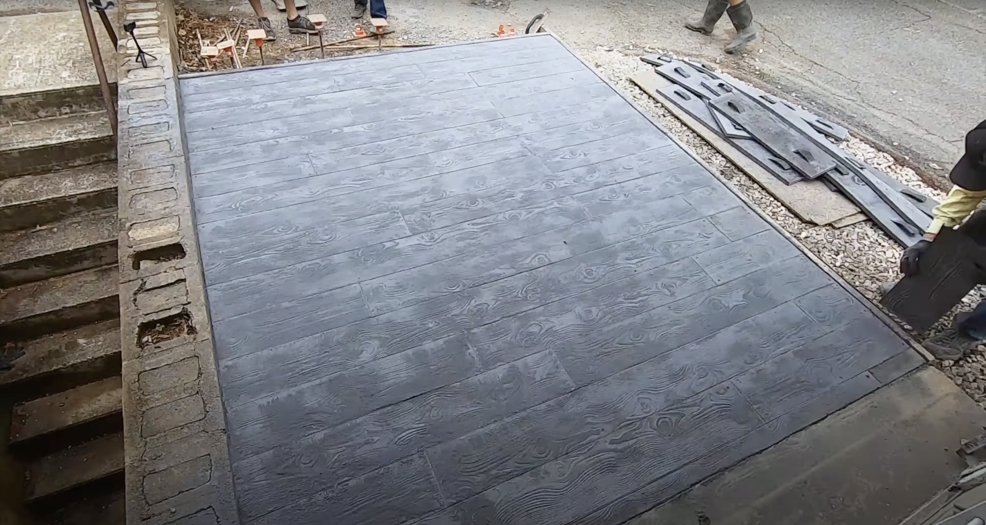 Freshly completed stamped concrete patio with wood plank pattern design